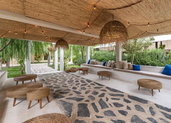 Pomme Garden’s inviting outdoor chilling area with a roof shelter and abundant surrounding greenery.